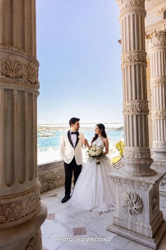 Bride and groom on the marble balcony of Küçüksu Palace overlooking the Bosphorus